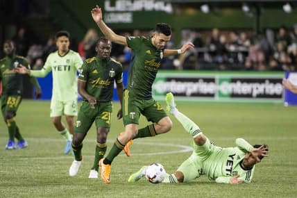 Mar 12, 2022; Portland, Oregon, USA; Austin FC forward Maximiliano Urruti (37) falls down during the first half against Portland Timbers midfielder Cristhian Paredes (22) at Providence Park. Mandatory Credit: Troy Wayrynen-USA TODAY Sports