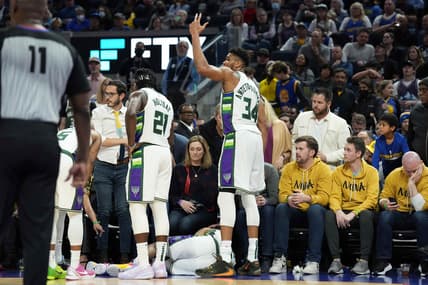 Mar 12, 2022; San Francisco, California, USA; Milwaukee Bucks forward Giannis Antetokounmpo (34) gestures as guard DeAndre' Bembry (95) lies on the floor during the third quarter at Chase Center. Mandatory Credit: Darren Yamashita-USA TODAY Sports