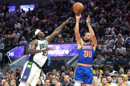 Mar 12, 2022; San Francisco, California, USA; Golden State Warriors guard Stephen Curry (30) shoots against Milwaukee Bucks guard Jrue Holiday (21) during the fourth quarter at Chase Center. Mandatory Credit: Darren Yamashita-USA TODAY Sports