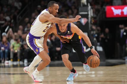 Mar 13, 2022; Phoenix, Arizona, USA; Phoenix Suns guard Devin Booker (1) dribbles against Los Angeles Lakers guard Avery Bradley (20) during the first half at Footprint Center. Mandatory Credit: Joe Camporeale-USA TODAY Sports