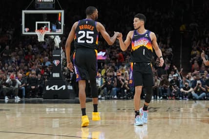 Mar 13, 2022; Phoenix, Arizona, USA; Phoenix Suns forward Mikal Bridges (25) and guard Devin Booker (1) bump fist during the first half against the Los Angeles Lakers at Footprint Center. Mandatory Credit: Joe Camporeale-USA TODAY Sports