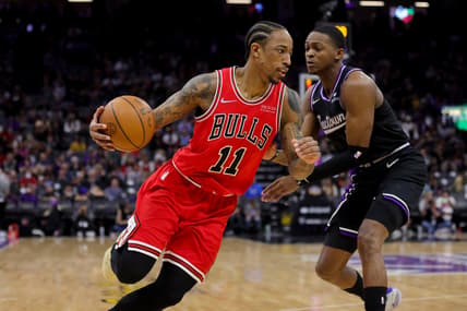 Mar 14, 2022; Sacramento, California, USA; Chicago Bulls forward DeMar DeRozan (11) dribbles the ball around Sacramento Kings guard De'Aaron Fox (5) during the third quarter at Golden 1 Center. Mandatory Credit: Sergio Estrada-USA TODAY Sports