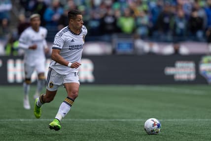 Mar 12, 2022; Seattle, Washington, USA; LA Galaxy forward Chicharito (14) dribbles the ball against Seattle Sounders FC at Lumen Field. Mandatory Credit: Stephen Brashear-USA TODAY Sports