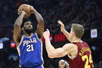Mar 16, 2022; Cleveland, Ohio, USA; Philadelphia 76ers center Joel Embiid (21) shoots beside Cleveland Cavaliers forward Lauri Markkanen (24) in the second quarter at Rocket Mortgage FieldHouse. Mandatory Credit: David Richard-USA TODAY Sports