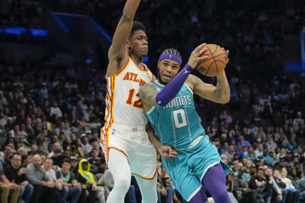Mar 16, 2022; Charlotte, North Carolina, USA; Charlotte Hornets forward Miles Bridges (0) drives to the basket defended by Atlanta Hawks forward De'Andre Hunter (12) during the second half at the Spectrum Center. Mandatory Credit: Jim Dedmon-USA TODAY Sports