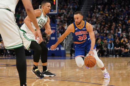 Mar 16, 2022; San Francisco, California, USA; Golden State Warriors guard Stephen Curry (30) dribbles past Boston Celtics forward Grant Williams (12) in the second quarter at the Chase Center. Mandatory Credit: Cary Edmondson-USA TODAY Sports
