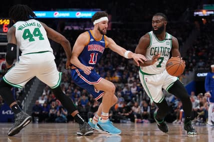 Mar 16, 2022; San Francisco, California, USA; Boston Celtics guard Jaylen Brown (7) dribbles the ball next to Golden State Warriors guard Klay Thompson (11) in the third quarter at the Chase Center. Mandatory Credit: Cary Edmondson-USA TODAY Sports