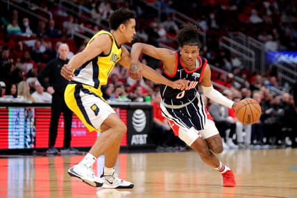 Mar 18, 2022; Houston, Texas, USA; Houston Rockets guard Jalen Green (0, right) handles the ball defended by Indiana Pacers guard Malcolm Brogdon (&) during the second quarter at Toyota Center. Mandatory Credit: Erik Williams-USA TODAY Sports