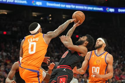 Mar 18, 2022; Phoenix, Arizona, USA; Chicago Bulls guard Coby White (0) attempts a shot over Phoenix Suns forward Torrey Craig (0) during the first half at Footprint Center. Mandatory Credit: Joe Camporeale-USA TODAY Sports