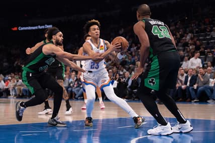Mar 21, 2022; Oklahoma City, Oklahoma, USA; Oklahoma City Thunder guard Tre Mann (23) moves the ball while defended by Boston Celtics guard Derrick White (9) and  center Al Horford (42) during the first half at Paycom Center. Mandatory Credit: Rob Ferguson-USA TODAY Sports