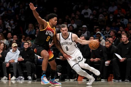Mar 21, 2022; Brooklyn, New York, USA; Brooklyn Nets guard Goran Dragic (9) dribbles around Utah Jazz forward Rudy Gay (8) during the second quarter at Barclays Center. Mandatory Credit: Brad Penner-USA TODAY Sports