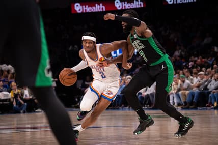 Mar 21, 2022; Oklahoma City, Oklahoma, USA; Oklahoma City Thunder guard Shai Gilgeous-Alexander (2) dribbles past Boston Celtics guard Jaylen Brown (7) during the first half at Paycom Center. Mandatory Credit: Rob Ferguson-USA TODAY Sports