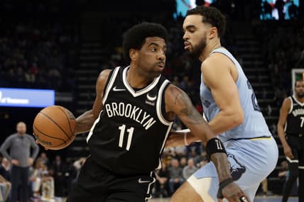 Mar 23, 2022; Memphis, Tennessee, USA; Brooklyn Nets guard Kyrie Irving (11) drives to the basket as Memphis Grizzlies guard Tyus Jones (21) defends during the first half at FedExForum. Mandatory Credit: Petre Thomas-USA TODAY Sports