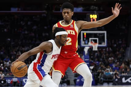 Mar 23, 2022; Detroit, Michigan, USA; Detroit Pistons forward Jerami Grant (9) dribbles defended by Atlanta Hawks forward De'Andre Hunter (12) in the second half at Little Caesars Arena. Mandatory Credit: Rick Osentoski-USA TODAY Sports