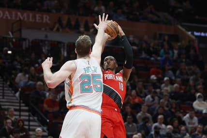 Mar 23, 2022; Portland, Oregon, USA; Portland Trail Blazers point guard Kris Dunn (18) shoots the ball over San Antonio Spurs center Jakob Poeltl (25) during the first half at Moda Center. Mandatory Credit: Soobum Im-USA TODAY Sports