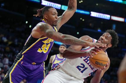 Mar 23, 2022; Los Angeles, California, USA; Philadelphia 76ers center Joel Embiid (21) is defended by Los Angeles Lakers center Dwight Howard (39) in the first half at Crypto.com Arena. Mandatory Credit: Kirby Lee-USA TODAY Sports