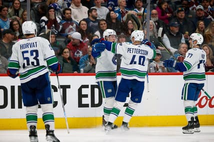 Mar 23, 2022; Denver, Colorado, USA; Vancouver Canucks right wing Brock Boeser (6) celebrates his goal with center Elias Pettersson (40) and defenseman Brad Hunt (77) and center Bo Horvat (53) in the third period against the Colorado Avalanche at Ball Arena. Mandatory Credit: Isaiah J. Downing-USA TODAY Sports