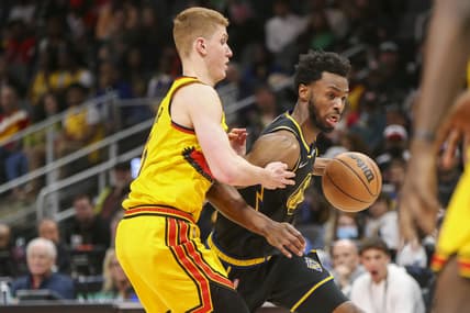 Mar 25, 2022; Atlanta, Georgia, USA; Golden State Warriors forward Andrew Wiggins (22) dribbles past Atlanta Hawks guard Kevin Huerter (3) in the second quarter at State Farm Arena. Mandatory Credit: Brett Davis-USA TODAY Sports
