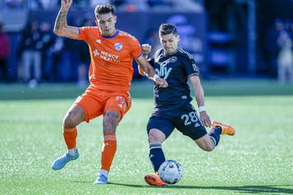 Mar 26, 2022; Charlotte, North Carolina, USA; Charlotte FC defender Joseph Mora (28) kicks defended by FC Cincinnati forward Brandon Vazquez (19) during the first half at Bank of America Stadium. Mandatory Credit: Jim Dedmon-USA TODAY Sports