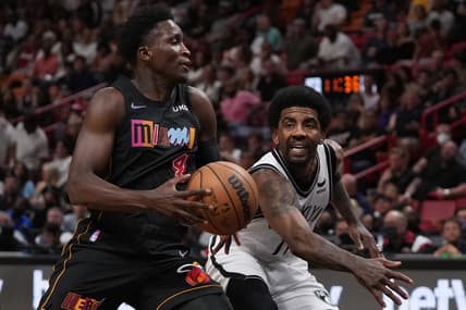 Mar 26, 2022; Miami, Florida, USA; Brooklyn Nets guard Kyrie Irving (11) knocks the ball away from Miami Heat guard Victor Oladipo (4) during the first half at FTX Arena. Mandatory Credit: Jasen Vinlove-USA TODAY Sports