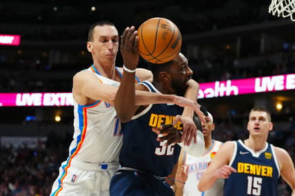 Mar 26, 2022; Denver, Colorado, USA; Oklahoma City Thunder center Aleksej Pokusevski (17) fouls Denver Nuggets forward Jeff Green (32) in the first quarter at Ball Arena. Mandatory Credit: Ron Chenoy-USA TODAY Sports