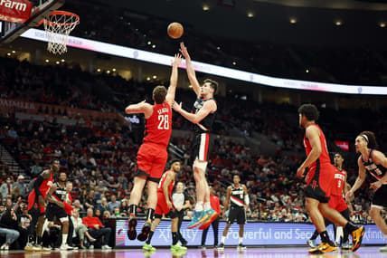 Mar 26, 2022; Portland, Oregon, USA; Portland Trail Blazers power forward Drew Eubanks (24) shoots the ball over Houston Rockets center Alperen Sengun (28) during the first half at Moda Center. Mandatory Credit: Soobum Im-USA TODAY Sports
