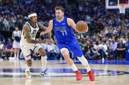Mar 27, 2022; Dallas, Texas, USA; Dallas Mavericks guard Luka Doncic (77) brings the ball up court past Utah Jazz guard Jordan Clarkson (00) during the second half at the American Airlines Center. Mandatory Credit: Jerome Miron-USA TODAY Sports