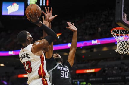 Mar 28, 2022; Miami, Florida, USA; Miami Heat center Bam Adebayo (13) shoots the basketball over Sacramento Kings center Damian Jones (30) during the first quarter at FTX Arena. Mandatory Credit: Sam Navarro-USA TODAY Sports