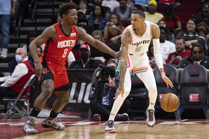 Mar 28, 2022; Houston, Texas, USA; San Antonio Spurs guard Dejounte Murray (5) dribbles against Houston Rockets forward Jae'Sean Tate (8) in the second quarter at Toyota Center. Mandatory Credit: Thomas Shea-USA TODAY Sports