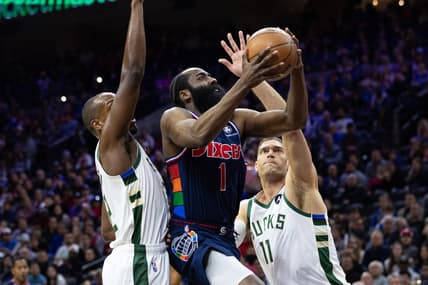 Mar 29, 2022; Philadelphia, Pennsylvania, USA; Philadelphia 76ers guard James Harden (1) drives for a score between Milwaukee Bucks forward Khris Middleton (22) and center Brook Lopez (11) during the first quarter at Wells Fargo Center. Mandatory Credit: Bill Streicher-USA TODAY Sports