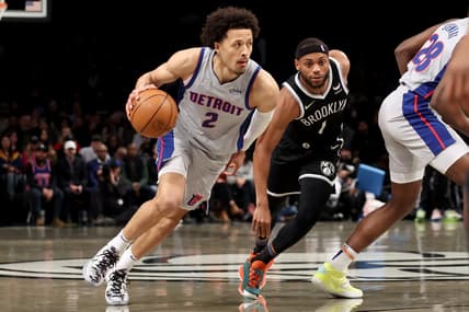 Mar 29, 2022; Brooklyn, New York, USA; Detroit Pistons guard Cade Cunningham (2) drives to the basket around Brooklyn Nets forward Bruce Brown (1) during the first quarter at Barclays Center. Mandatory Credit: Brad Penner-USA TODAY Sports