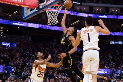 Mar 30, 2022; San Francisco, California, USA; Phoenix Suns forward Mikal Bridges (25) and guard Devin Booker (1) defend against Golden State Warriors guard Jordan Poole (3) during the first half at Chase Center. Mandatory Credit: John Hefti-USA TODAY Sports