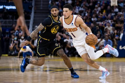 Mar 30, 2022; San Francisco, California, USA; Phoenix Suns guard Devin Booker (1) dribbles past Golden State Warriors guard Gary Payton II (0) during the second half at Chase Center. Mandatory Credit: John Hefti-USA TODAY Sports