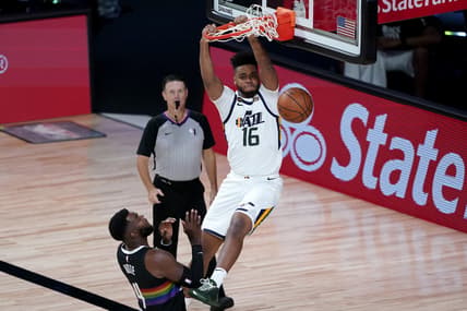 Aug 19, 2020; Lake Buena Vista, Florida, USA; Utah Jazz's Juwan Morgan (16) dunks as Denver Nuggets' Paul Millsap (4) looks on during the second half of an NBA basketball first round playoff game. Mandatory Credit: Ashley Landis/Pool Photo via USA TODAY Sports