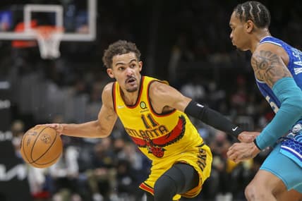 Dec 5, 2021; Atlanta, Georgia, USA; Atlanta Hawks guard Trae Young (11) dribbles the ball as Charlotte Hornets forward P.J. Washington (25) defends in the second half at State Farm Arena. Mandatory Credit: Brett Davis-USA TODAY Sports