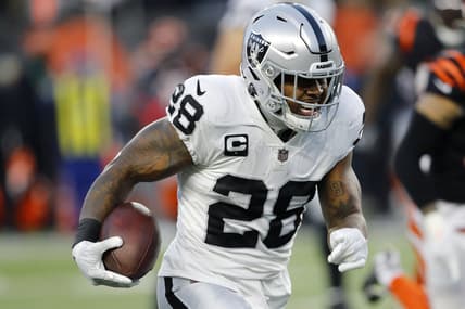 Jan 15, 2022; Cincinnati, Ohio, USA; Las Vegas Raiders running back Josh Jacobs (28) runs during the second quarter in an AFC Wild Card playoff football game against the Cincinnati Bengals at Paul Brown Stadium. Mandatory Credit: Joseph Maiorana-USA TODAY Sports