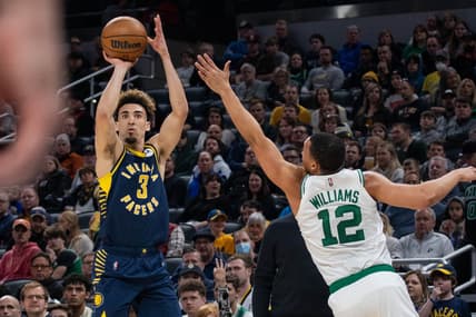 Feb 27, 2022; Indianapolis, Indiana, USA; Indiana Pacers guard Chris Duarte (3) shoots the ball while Boston Celtics forward Grant Williams (12) defends in the first half at Gainbridge Fieldhouse. Mandatory Credit: Trevor Ruszkowski-USA TODAY Sports