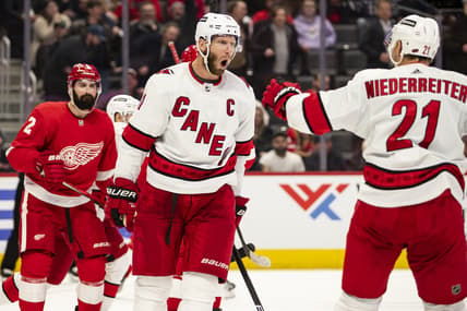 Mar 1, 2022; Detroit, Michigan, USA; Carolina Hurricanes center Jordan Staal (11) celebrates with right wing Nino Niederreiter (21) after scoring a goal during the third period against the Detroit Red Wings at Little Caesars Arena. Mandatory Credit: Raj Mehta-USA TODAY Sports
