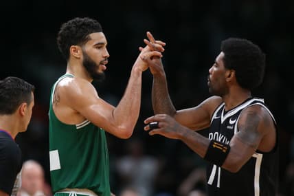 Mar 6, 2022; Boston, Massachusetts, USA; Brooklyn Nets guard Kyrie Irving (11) and Boston Celtics forward Jayson Tatum (0) high five during the second half at TD Garden. Mandatory Credit: Paul Rutherford-USA TODAY Sports