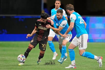 Mar 13, 2022; Atlanta, Georgia, USA; Atlanta United midfielder Marcelino Moreno (10) dribbles the ball against Charlotte FC midfielder Brandt Bronico (13) during the second half at Mercedes-Benz Stadium. Atlanta United won 2-1. Mandatory Credit: Dale Zanine-USA TODAY Sports