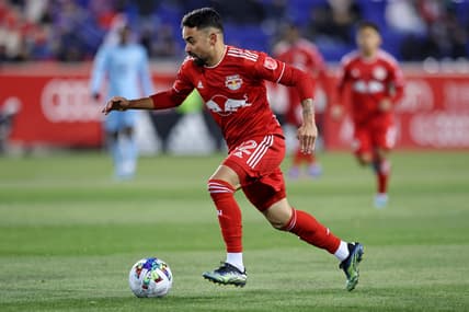 Mar 13, 2022; Harrison, New Jersey, USA; New York Red Bulls midfielder Luquinhas (82) dribbles the ball against Minnesota United during the second half at Red Bull Arena. Mandatory Credit: Vincent Carchietta-USA TODAY Sports