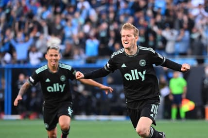 Mar 26, 2022; Charlotte, North Carolina, USA;  Charlotte FC forward Karol Swiderski (11) celebrates with midfielder Jordy Alcivar (8) after scoring a goal in the second half at Bank of America Stadium. Mandatory Credit: Bob Donnan-USA TODAY Sports