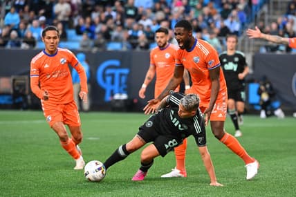 Mar 26, 2022; Charlotte, North Carolina, USA; Charlotte FC midfielder Jordy Alcivar (8) with the ball as FC Cincinnati forward Yuya Kubo (7) and defender Tyler Blackett (24) defend in the second half at Bank of America Stadium. Mandatory Credit: Bob Donnan-USA TODAY Sports
