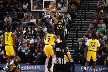 Mar 31, 2022; Salt Lake City, Utah, USA; Utah Jazz center Rudy Gobert (27) dunks the ball against Los Angeles Lakers forward Carmelo Anthony (7) in the second quarter at Vivint Arena. Mandatory Credit: Jeffrey Swinger-USA TODAY Sports