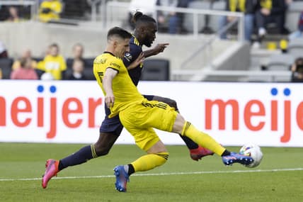 Apr 2, 2022; Columbus, Ohio, USA; Columbus Crew defender Milos Degenek (5) knocks the ball away from Nashville SC forward C.J. Sapong (17) in the first half at Lower.com Field. Mandatory Credit: Greg Bartram-USA TODAY Sports