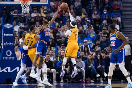 Apr 2, 2022; San Francisco, California, USA;  Golden State Warriors forward Andrew Wiggins (22) blocks a shot by Utah Jazz guard Mike Conley (11) during the first half at Chase Center. Mandatory Credit: John Hefti-USA TODAY Sports