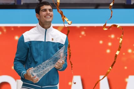 Apr 3, 2022; Miami Gardens, FL, USA; Carlos Alcaraz (ESP) celebrates with the Butch Buchholz Championship Trophy after his match against Casper Ruud (NOR)(not pictured) in the men's singles final in the Miami Open at Hard Rock Stadium. Mandatory Credit: Geoff Burke-USA TODAY Sports