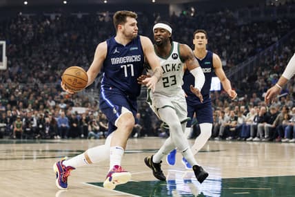 Apr 3, 2022; Milwaukee, Wisconsin, USA;  Dallas Mavericks guard Luka Doncic (77) drives for the basket against Milwaukee Bucks guard Wesley Matthews (23) during the first quarter at Fiserv Forum. Mandatory Credit: Jeff Hanisch-USA TODAY Sports