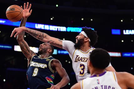 Apr 3, 2022; Los Angeles, California, USA; Los Angeles Lakers forward Anthony Davis (3) blocks the shot of Denver Nuggets guard Davon Reed (9) during the first half at Crypto.com Arena. Mandatory Credit: Gary A. Vasquez-USA TODAY Sports