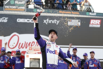 Apr 3, 2022; Richmond, Virginia, USA; NASCAR Cup Series driver Denny Hamlin (11) celebrates in Victory Lane after winning the Toyota Owners 400 at Richmond International Raceway. Mandatory Credit: Amber Searls-USA TODAY Sports